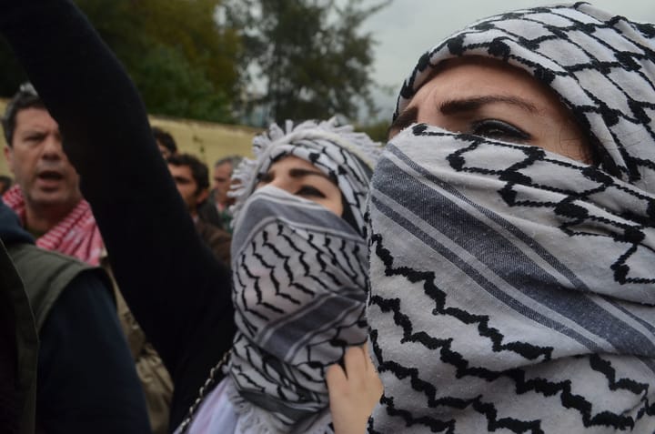 Two women in kaffiyas are pictured.